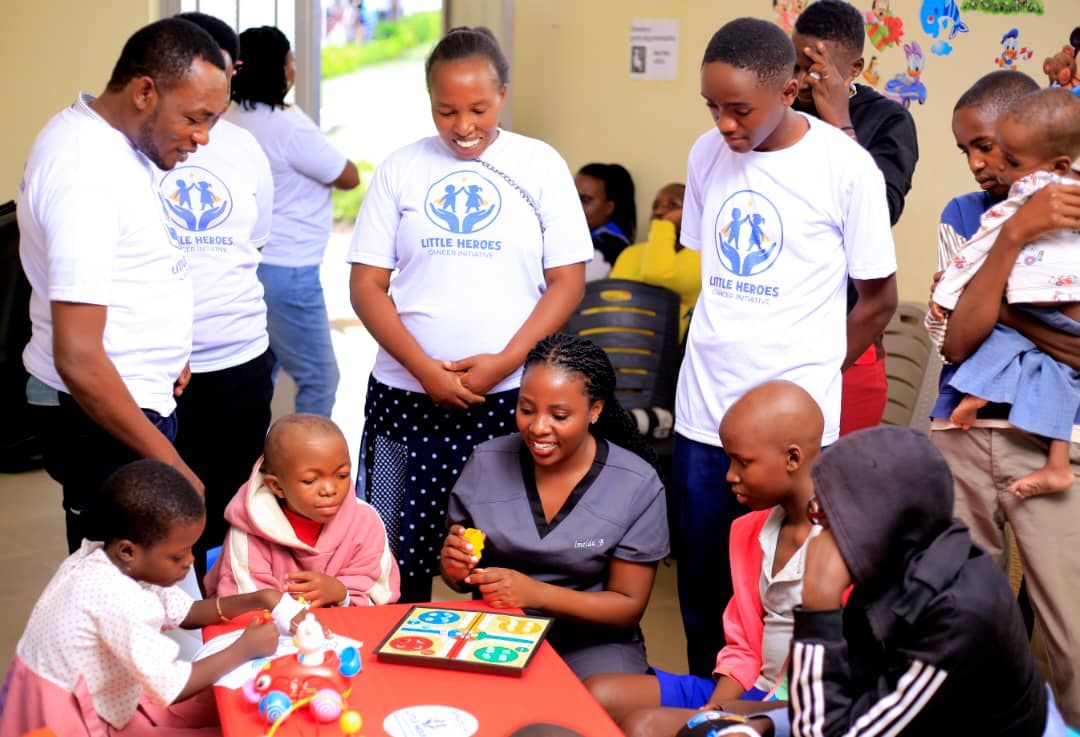 Team members watching children play a board game