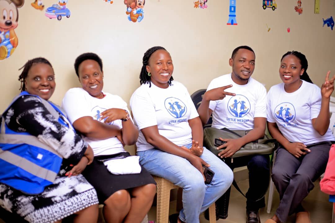 Little Heroes team members seated together and smiling