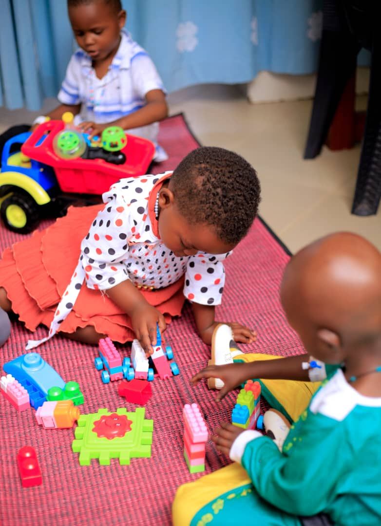 Children playing with building blocks on a mat