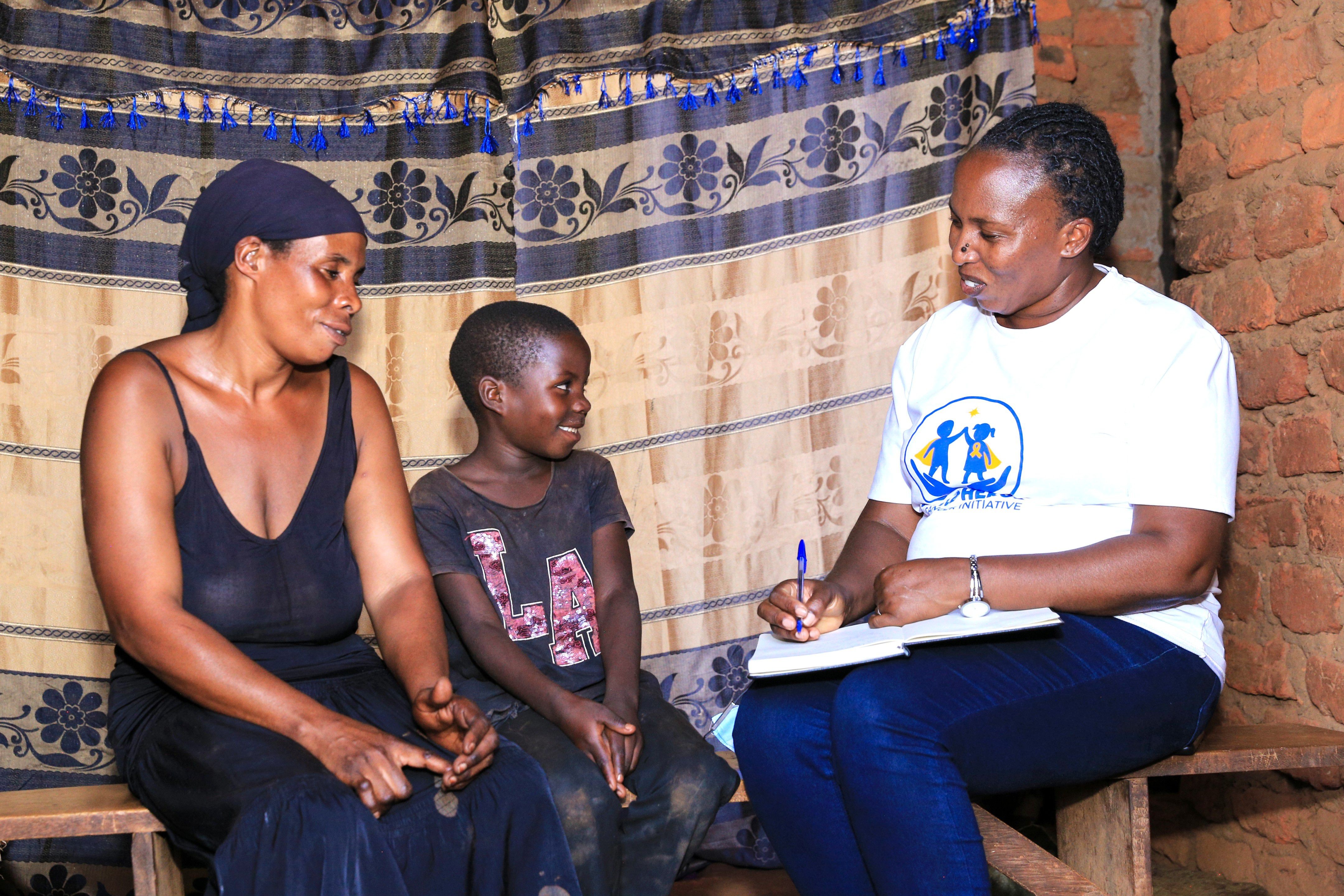 Little Heroes founder listening to a child and caregiver during a home visit