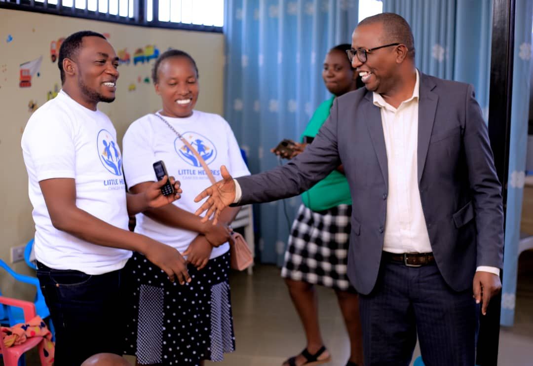 Partner shaking hands with Little Heroes team members