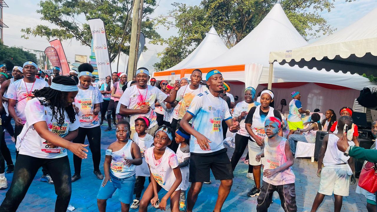 Crowd of runners celebrating at a colourful community run