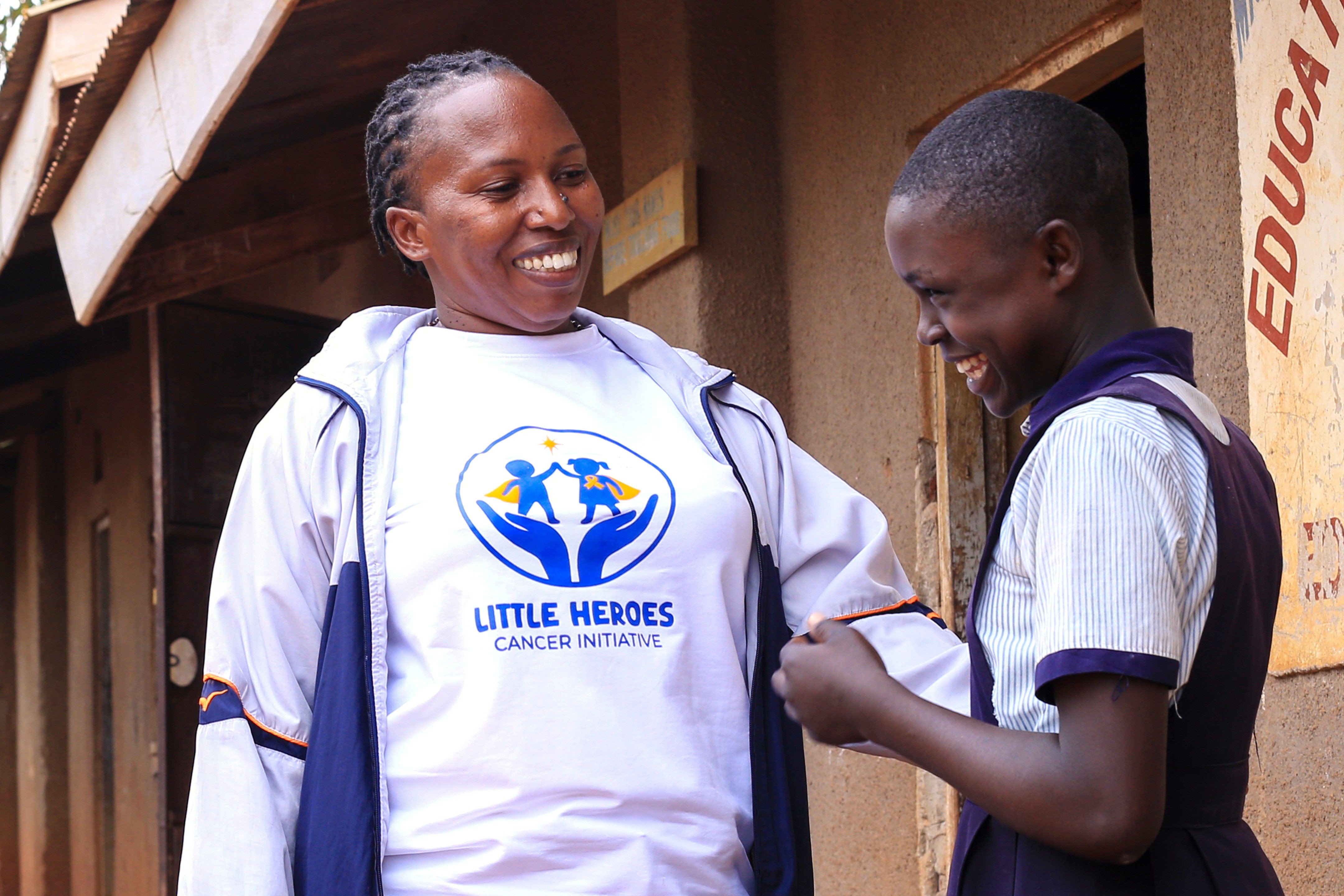 Little Heroes founder laughing with a student during a school visit